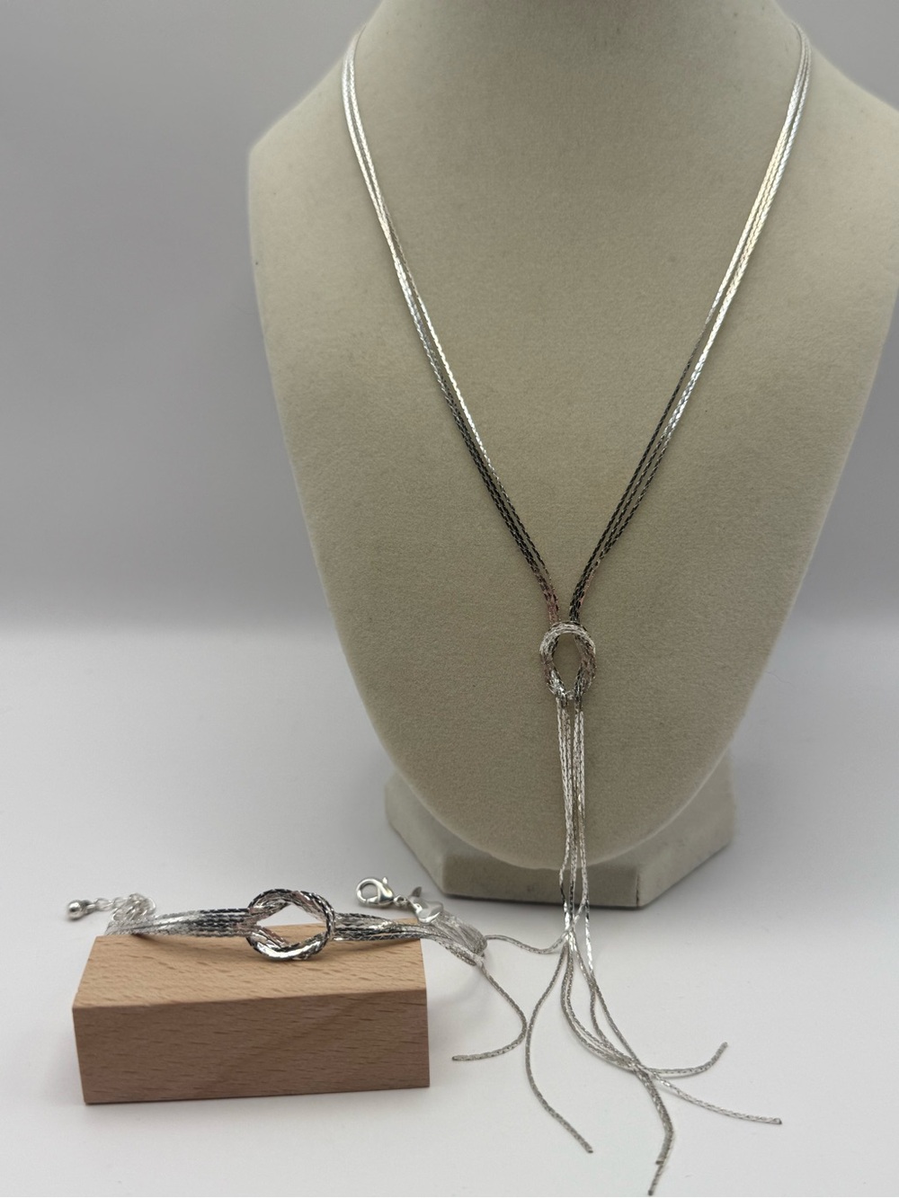 Multi -Strand Lariat Necklace with Textured Ring and Tassel Detail